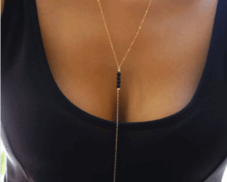 Gold costume jewelry necklace with black bead detail